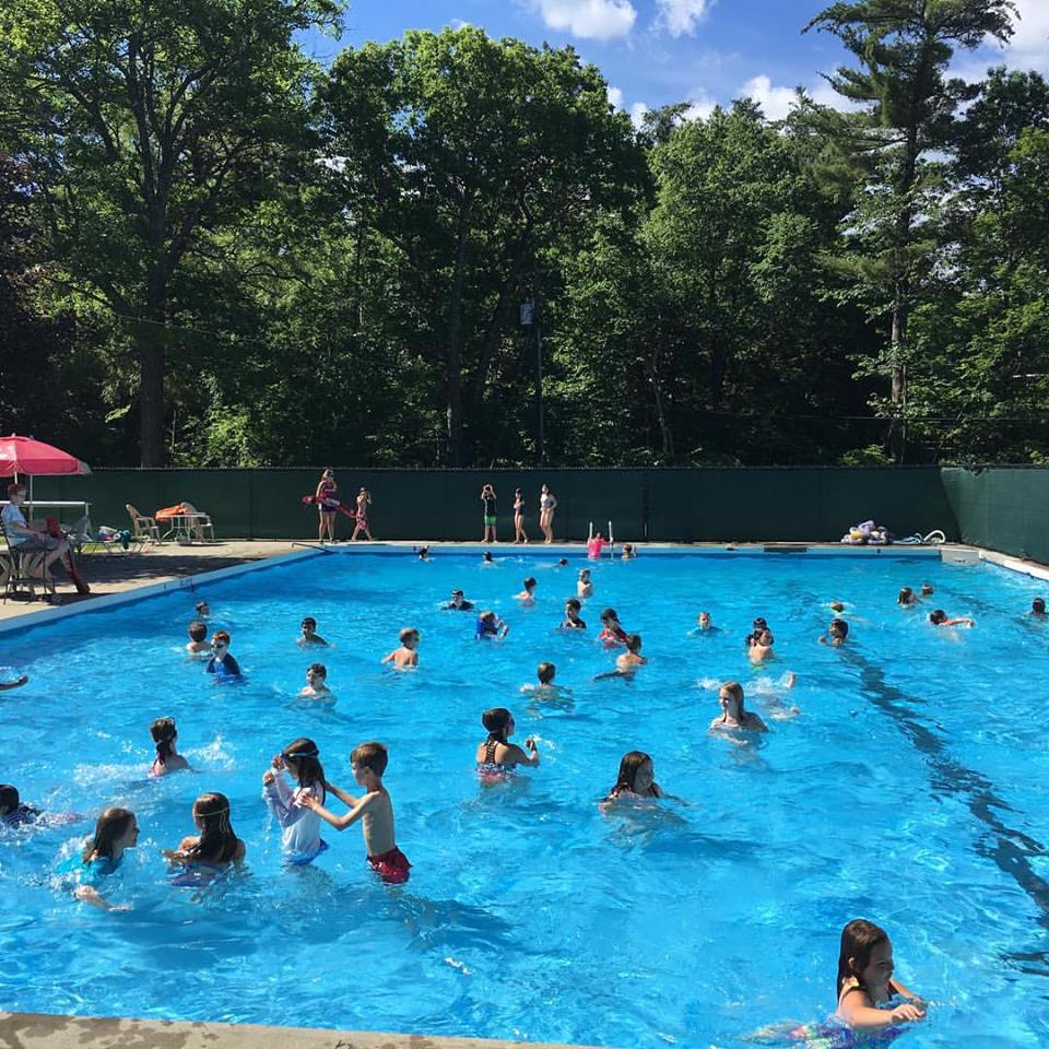 people swimming in a public pool